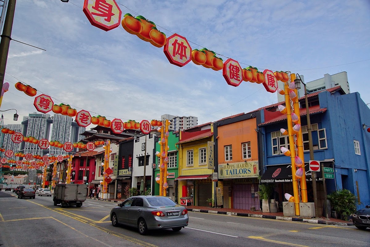 South Bridge Road with lantern arches, Happy Harry's yellow shopfront among the shophouses